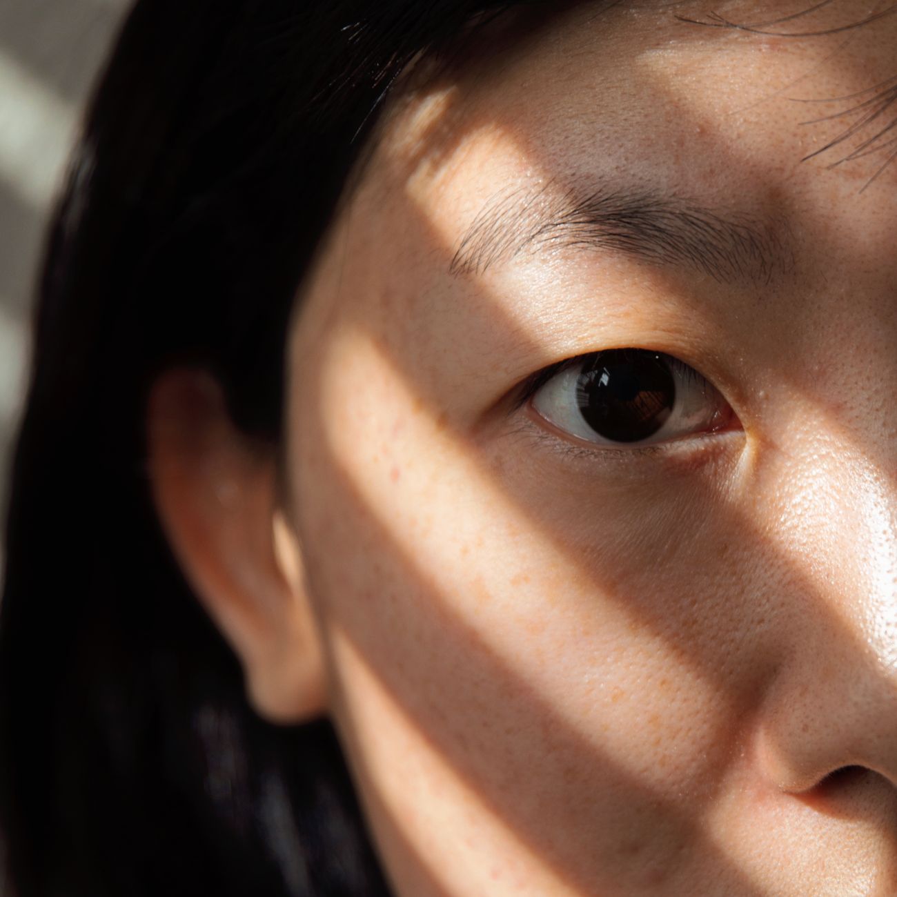 portrait of smiling woman with glossy highlighted hair in natural light